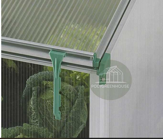 Detailed view of the plastic support bracket clipped onto the frame of a mini greenhouse planter box with vegetables inside.